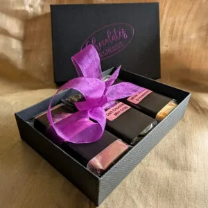 Handmade luxury chocolate gift box wrapped with purple ribbon