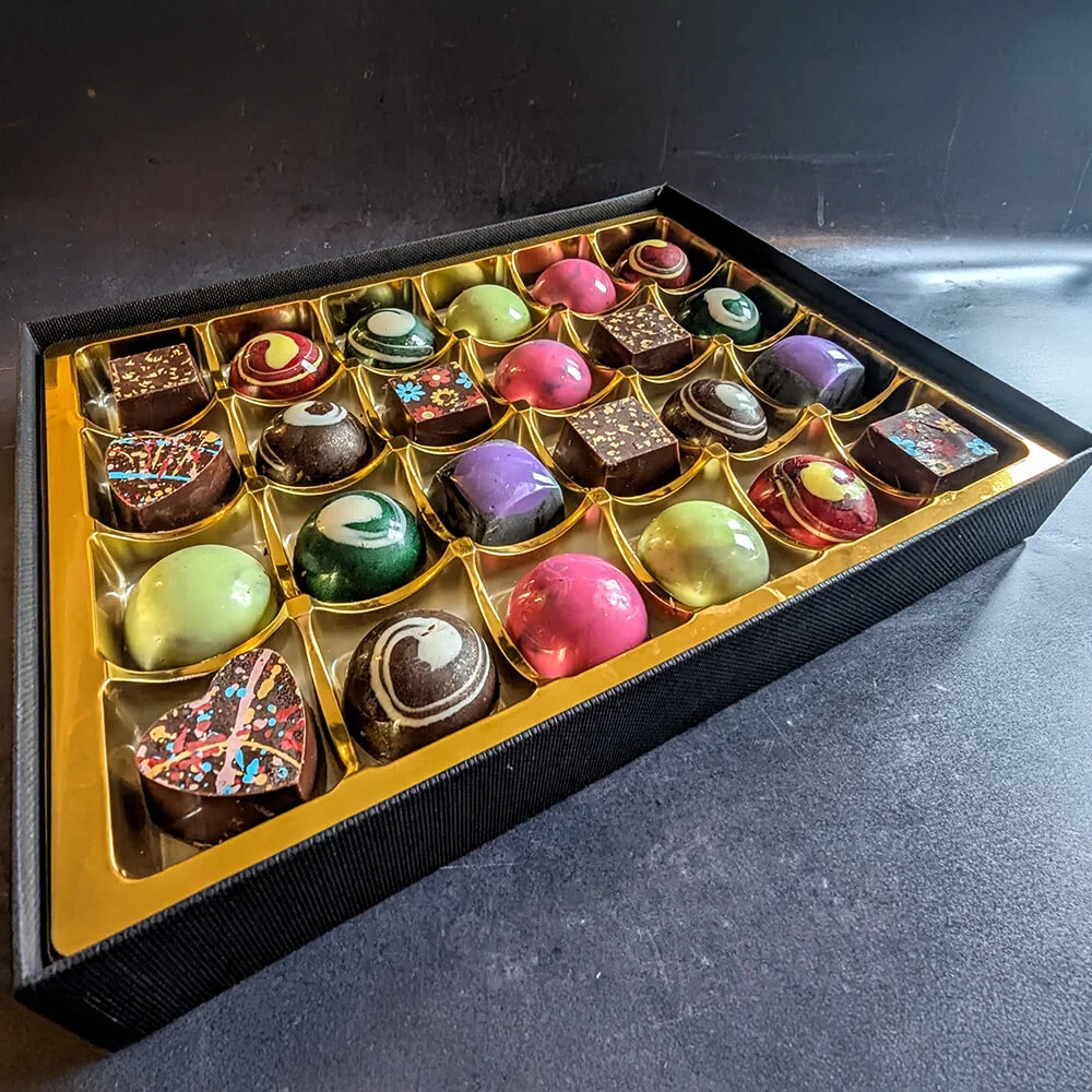 Colourful handcrafted vegan chocolates in luxury packaging