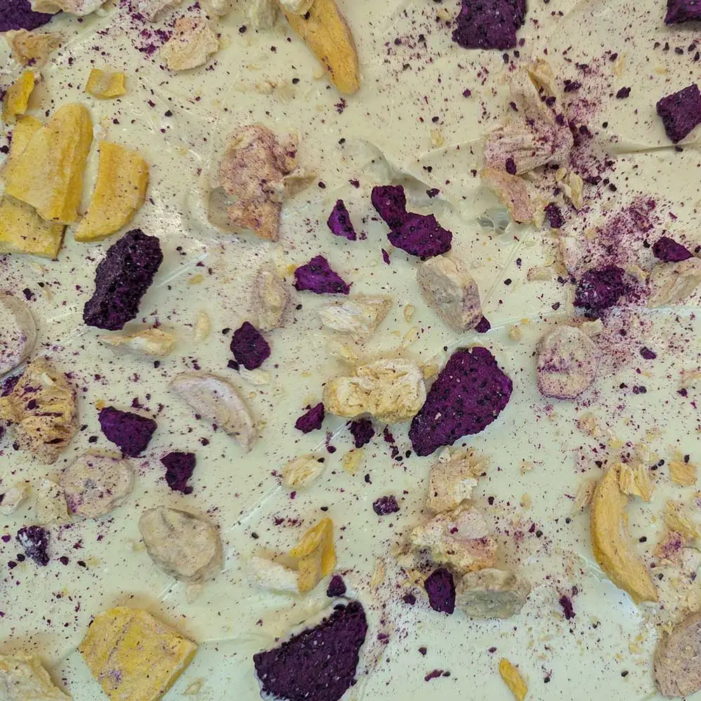 Luxury white chocolate bark with fruit and pistachio by Chocolates by Design.