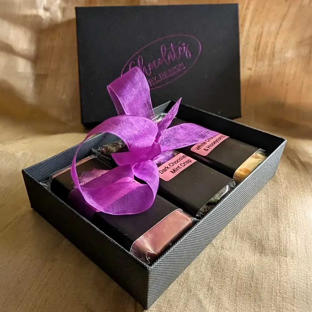 Handmade luxury chocolate gift box wrapped with purple ribbon