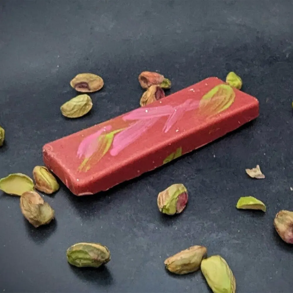 Artisan chocolate bar topped with nuts and fruit pieces