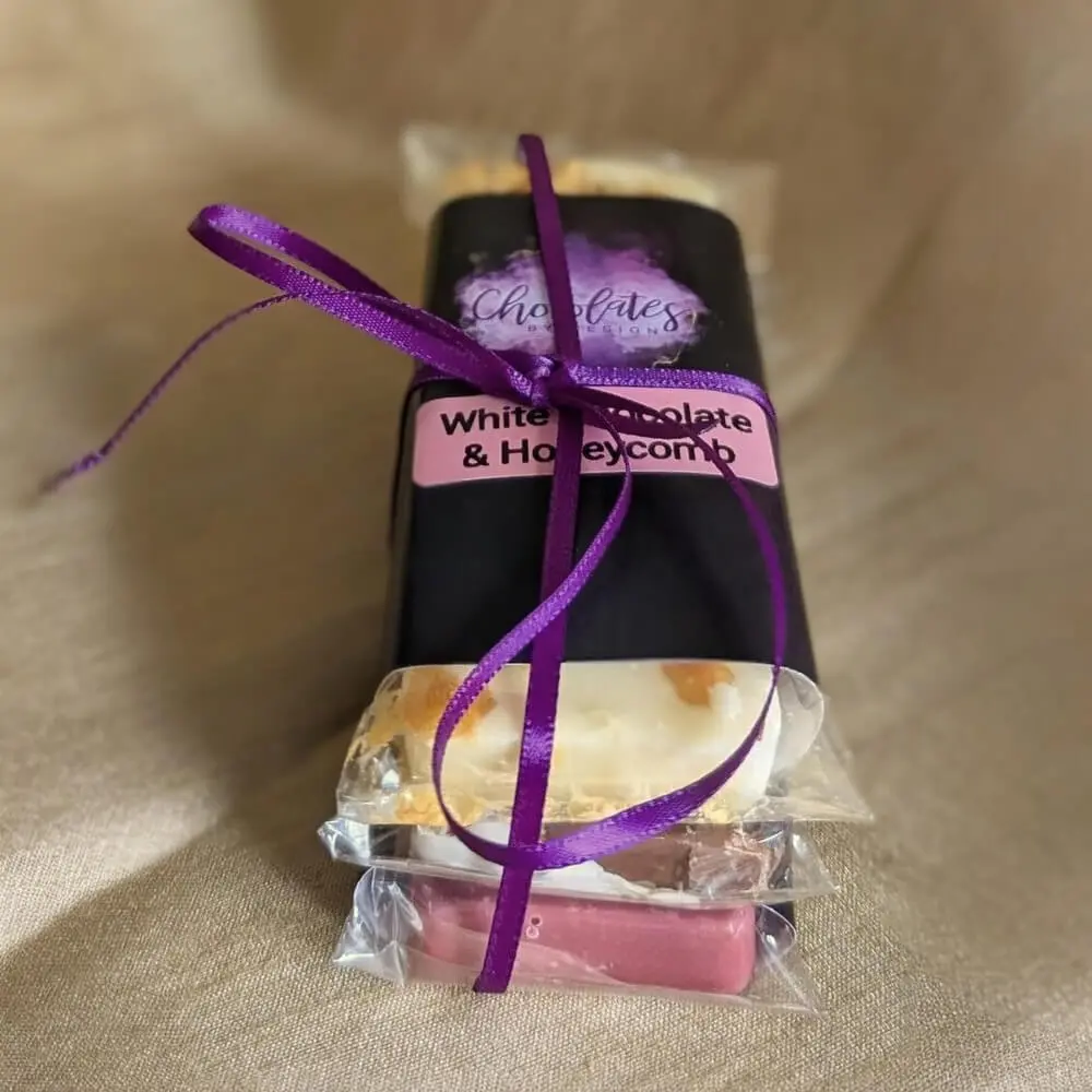 Premium chocolate gift box tied with elegant purple ribbon